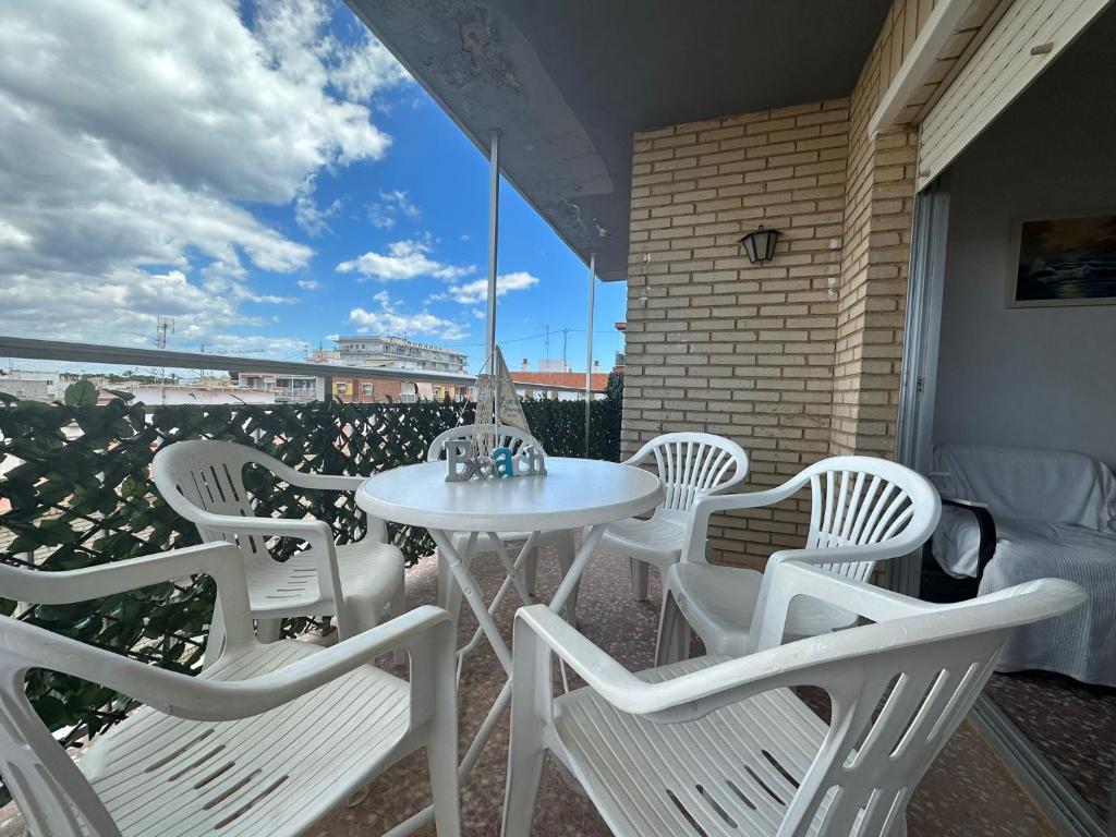 a white table and chairs on a balcony at Puerto de Lo Pagan in San Pedro del Pinatar