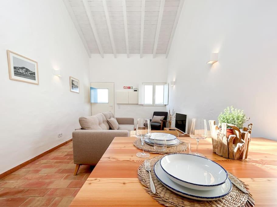 a living room with a table and a couch at Casa das Piteiras nº3 - Aljezur in Aljezur