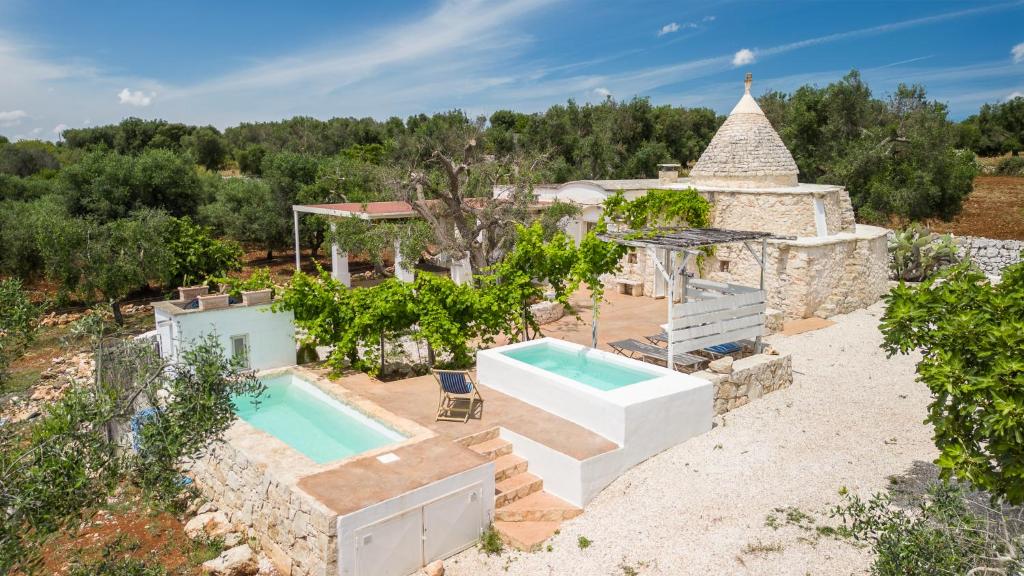 an aerial view of a villa with a swimming pool at Trullo Solleone con piscine by Wonderful Italy in Carovigno