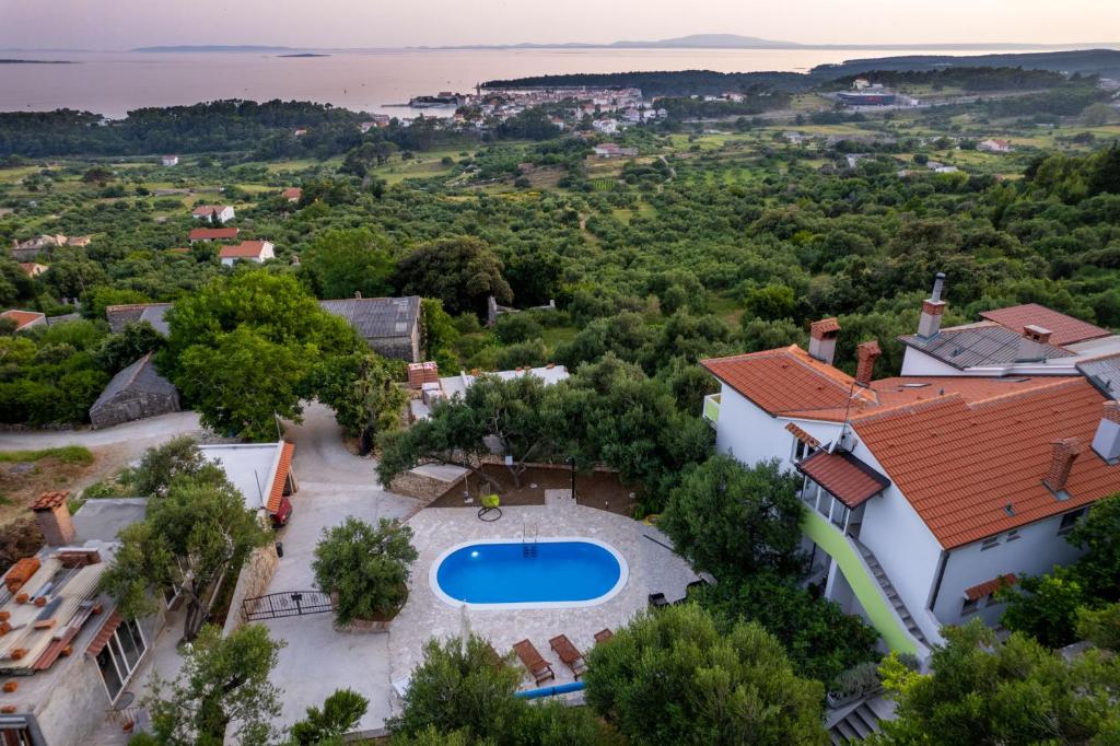 an aerial view of a house with a swimming pool at Apartmani Pero Dido in Rab