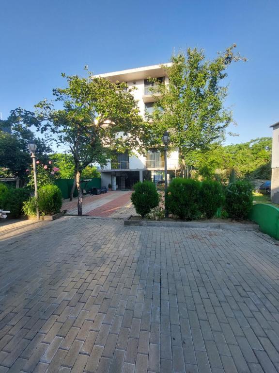 a person riding a bike down a brick road at Green Terrace in Kobuleti