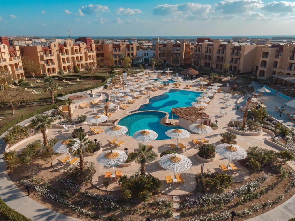 an aerial view of a resort with umbrellas and a pool at Lemon & Soul Makadi Garden in Hurghada