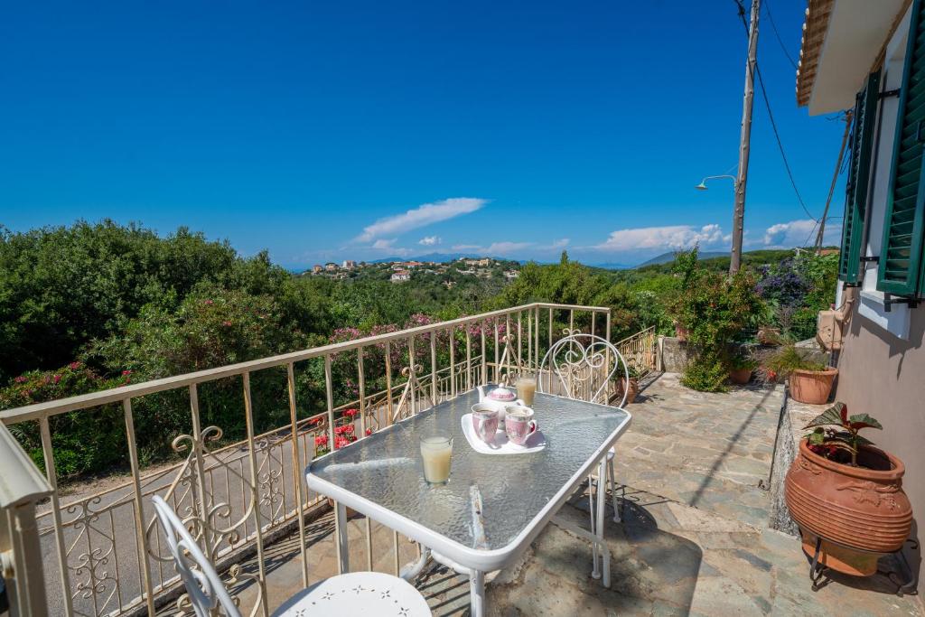a table with two figurines on it on a balcony at Pitoros Summer Cottage Kefalonia in Mesovoúnia