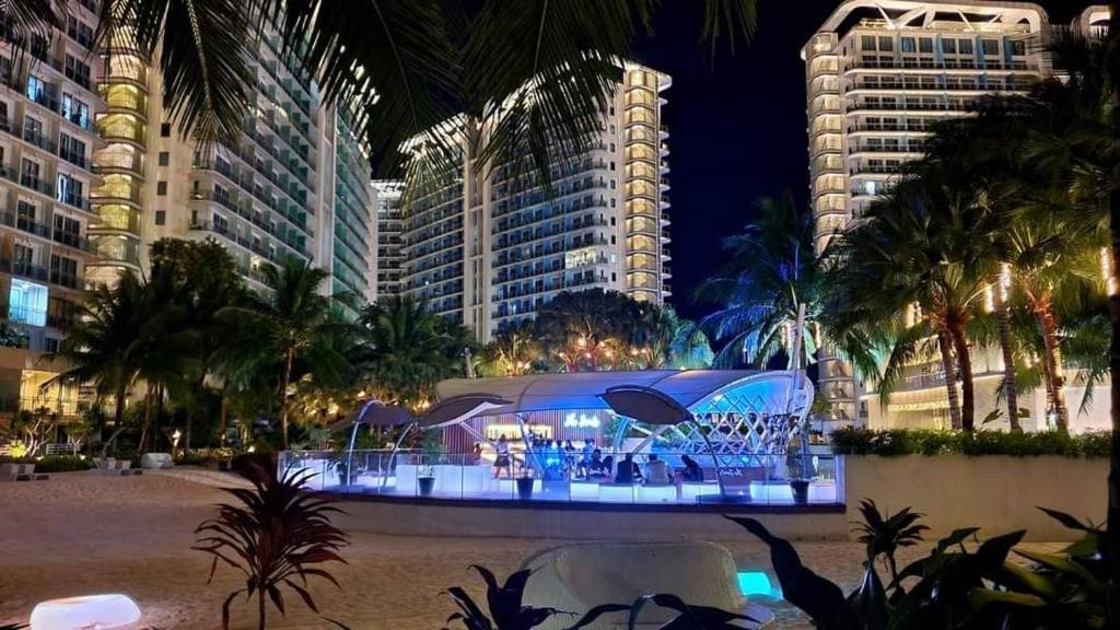 a night view of a building with people in it at Manila Urban Resort at Azure in Manila