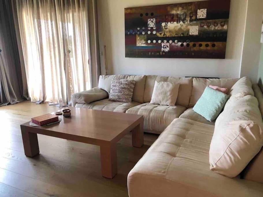 a living room with a couch and a coffee table at Villa Casa Chrissy in Plagiárion