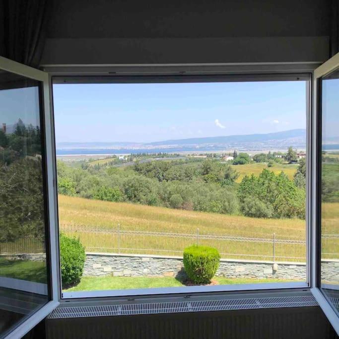 a window in a room with a view of a field at Villa Casa Chrissy in Plagiárion