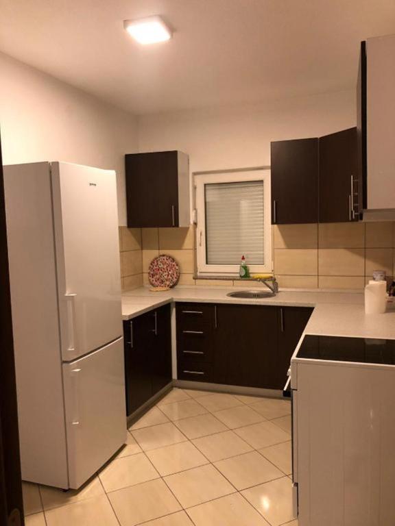 a kitchen with a white refrigerator and a sink at Villa Predlug in Čapljina