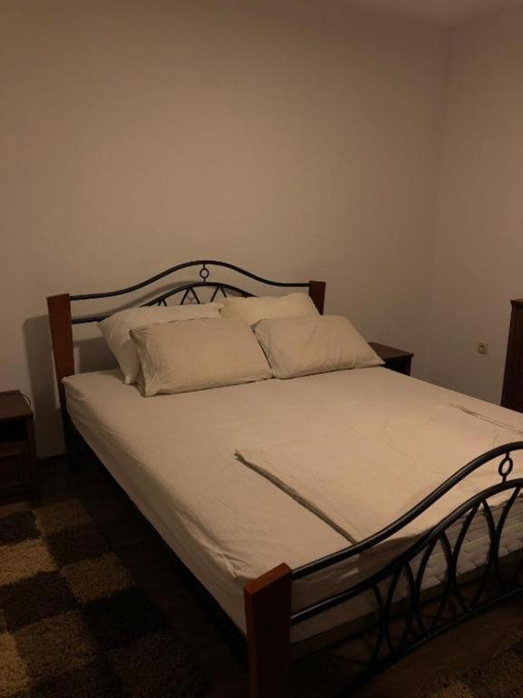 a bedroom with a bed with white sheets and pillows at Villa Predlug in Čapljina
