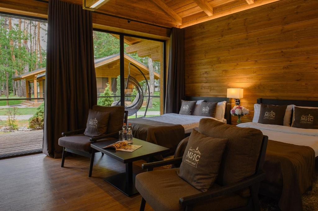 a bedroom with a bed and a bed and a couch at Мис Доброї Надії Полтава in Hlody
