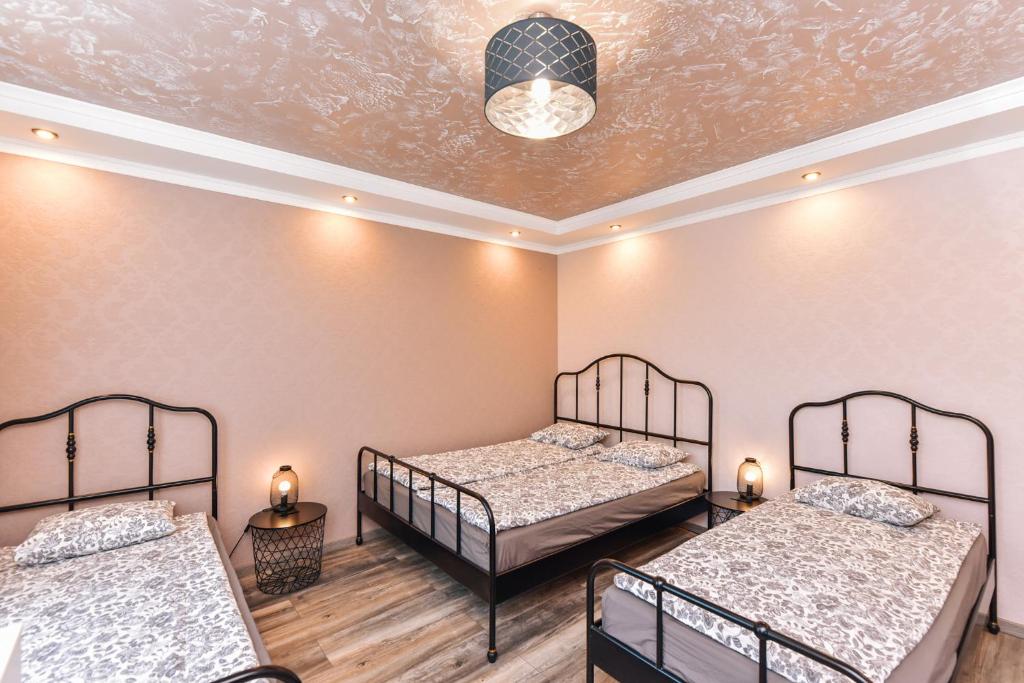 a room with two beds and a ceiling at Meldernams in Ventspils