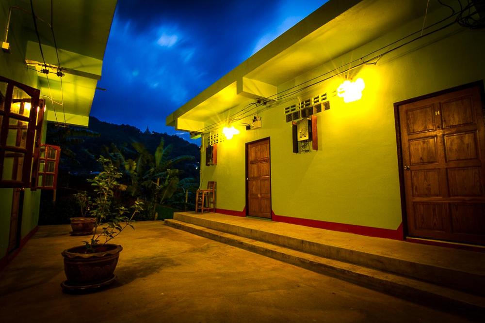 a building with a door and a porch at night at My Place Mae Salong in Ban A Ku