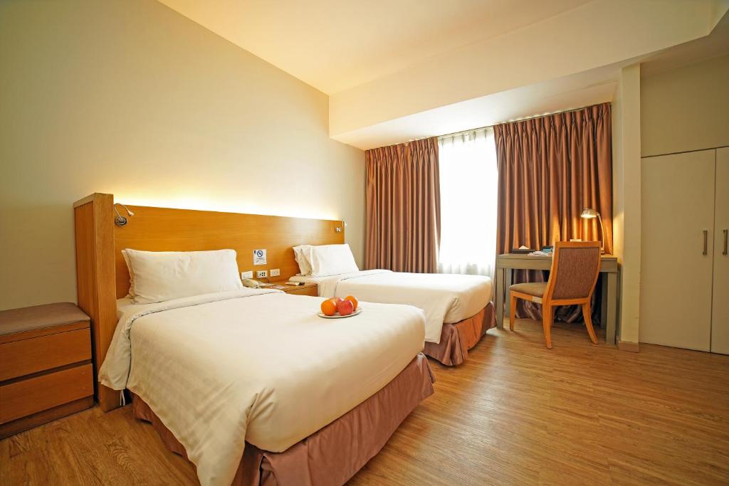 Llit o llits en una habitació de One Pacific Place Serviced Residences