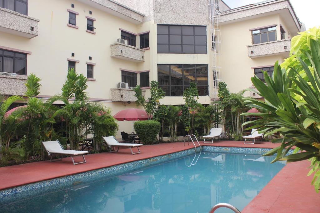 a swimming pool in front of a building at Carlson Hotel, Osborne Foreshore Phase 2, Ikoyi in Lagos