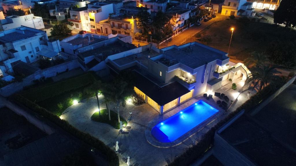 an aerial view of a house at night with a swimming pool at b&b Villa Grazia in Leverano