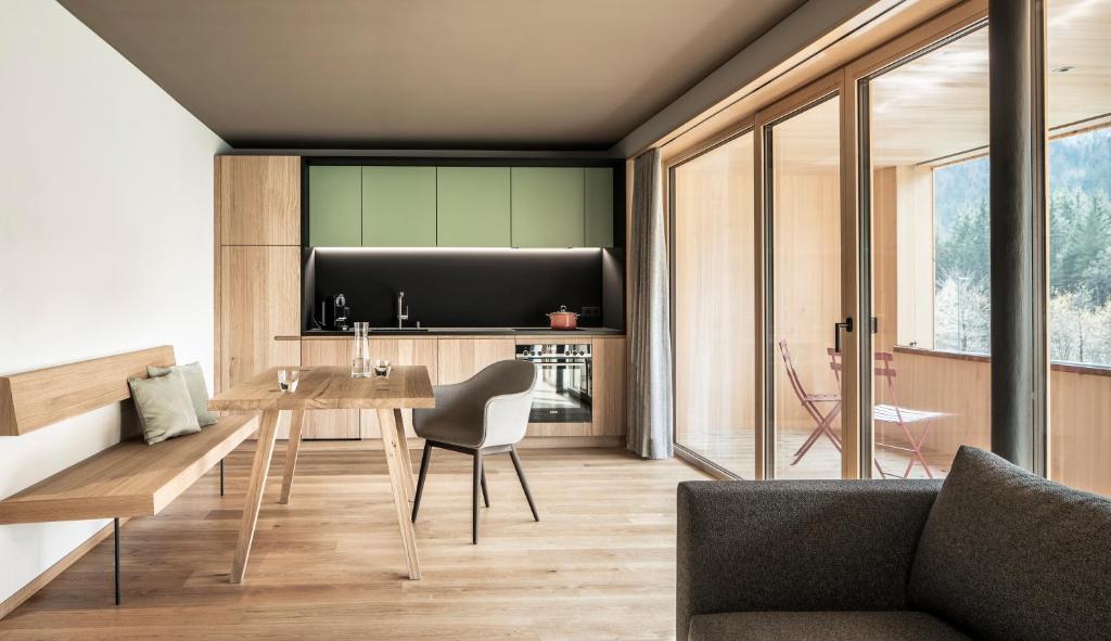 a living room with a table and a couch at freiraum Apartments in Mellau