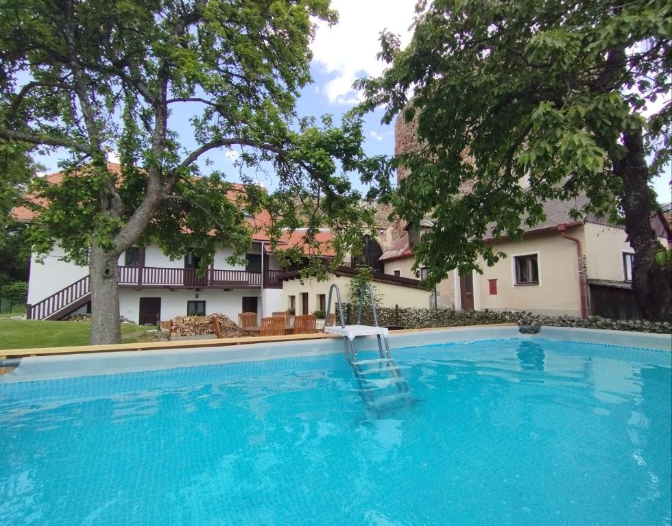 a large swimming pool in front of a house at Vila Anička Vimperk in Vimperk
