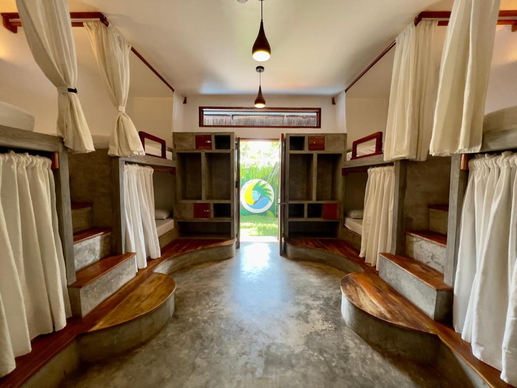 a room with bunk beds and a door at Chief Mau Moalboal Cebu in Moalboal
