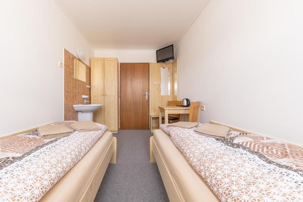 Postel nebo postele na pokoji v ubytování Hotel Pivovar Polička