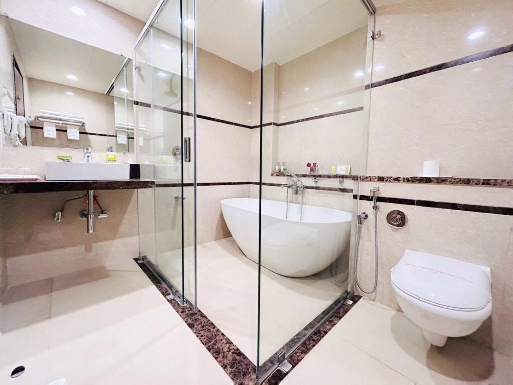 y baño con aseo y ducha acristalada. en Boulevard 9 Luxury Resort & Spa, en Nadiād