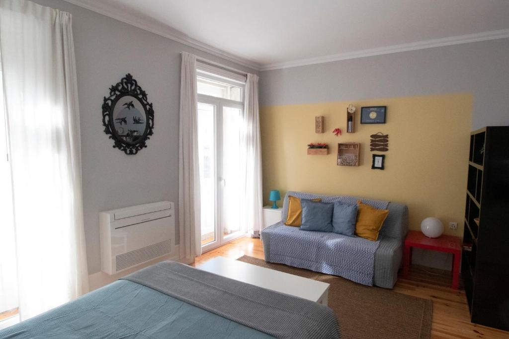 salon z łóżkiem i kanapą w obiekcie OPorto Histórico - Galerias w Porto