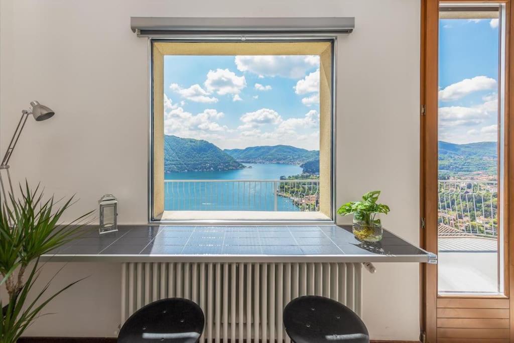 a window with a view of a body of water at Vivi Il Lago - Lake View in Cernobbio