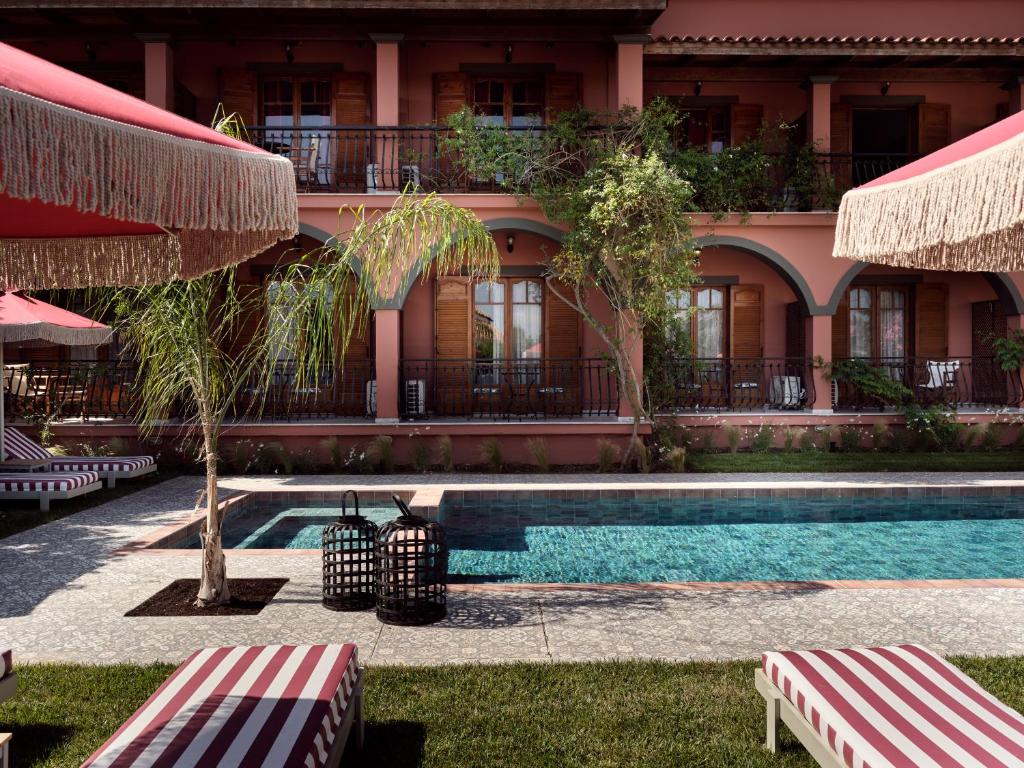 a resort with a swimming pool and a building at Anemelia Retreat in Laganas