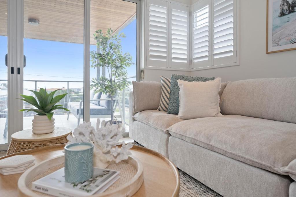 a living room with a couch and a table at The Haven on Blue Bay in Mandurah
