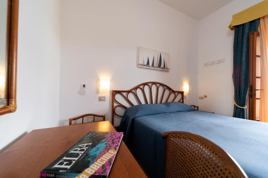 Postel nebo postele na pokoji v ubytování Albergo Le Briciole