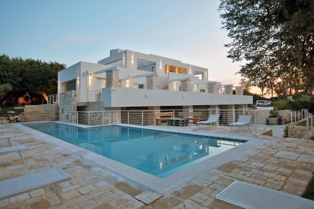 a house with a swimming pool in front of it at MEDITERRANEO RELAX in Polignano a Mare