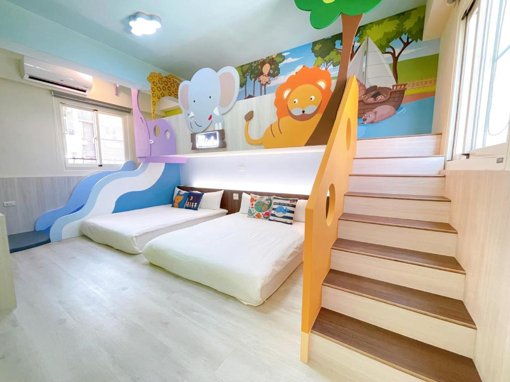 a childrens room with a bunk bed and stairs at Misto B&amp;B in Taitung City