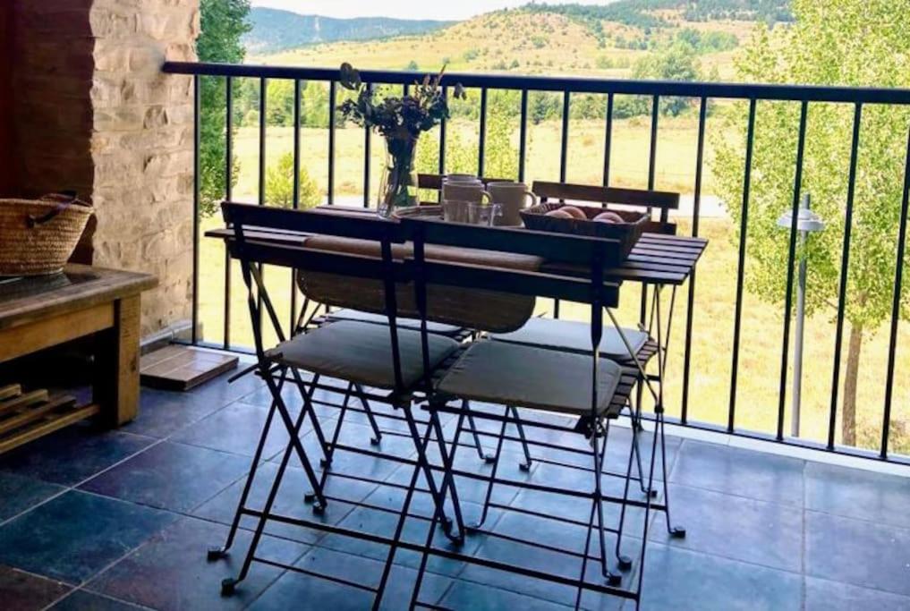 a table and chairs on a balcony with a view at Fantastic duplex surrounded by nature (Ski&Golf) in Teruel