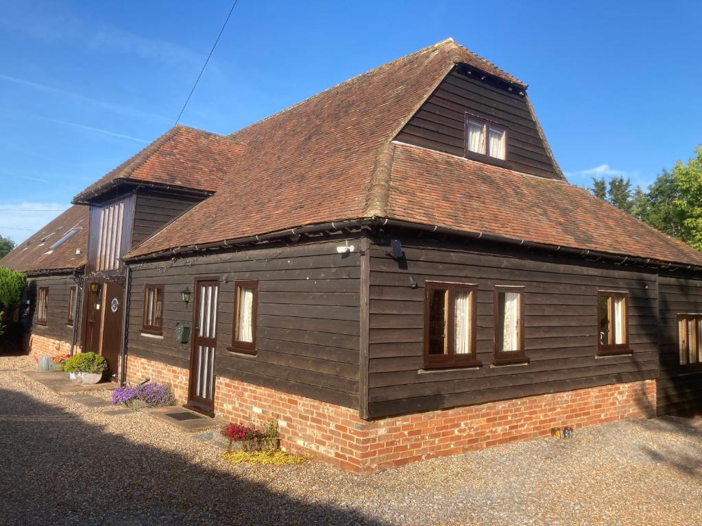 a small house with a brown roof at The Manger at Bethersden, nr Tenterden and Ashford in Bethersden