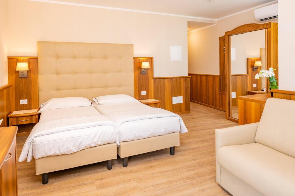 Postel nebo postele na pokoji v ubytování Hotel Centrale