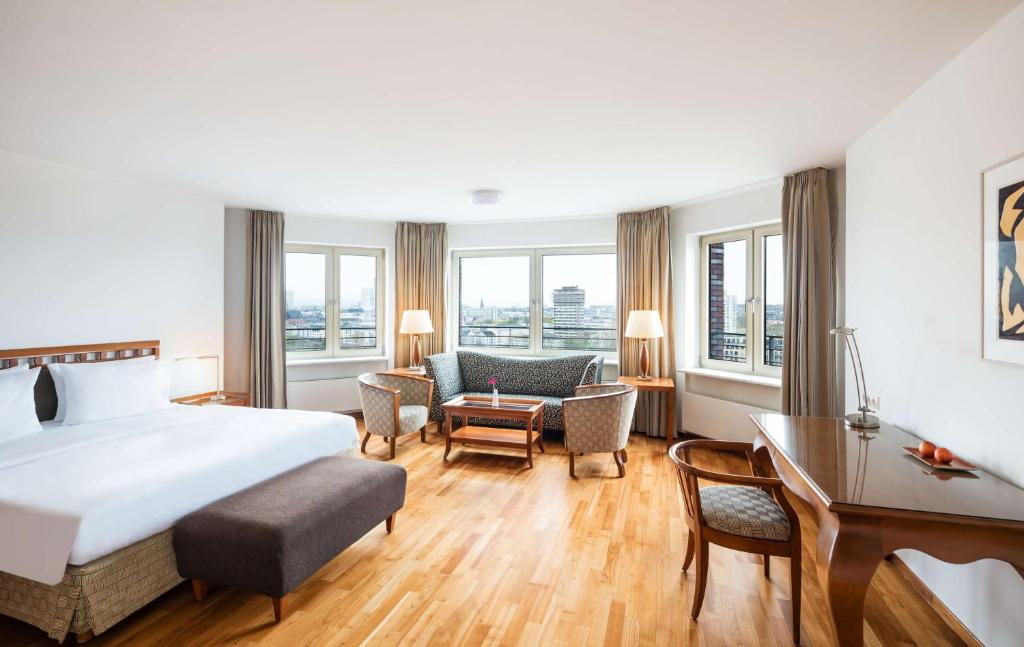 a hotel room with a bed and a desk at Lindner Hotel Frankfurt Main Plaza, part of JdV by Hyatt in Frankfurt/Main