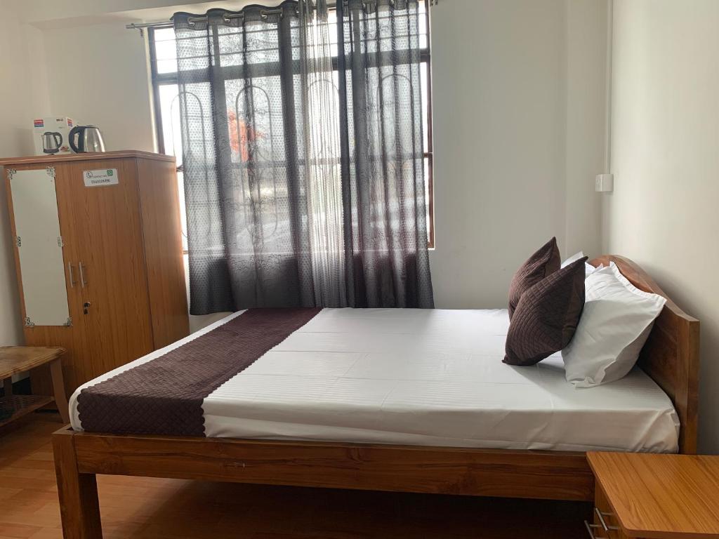 Postel nebo postele na pokoji v ubytování Aama Home Stay