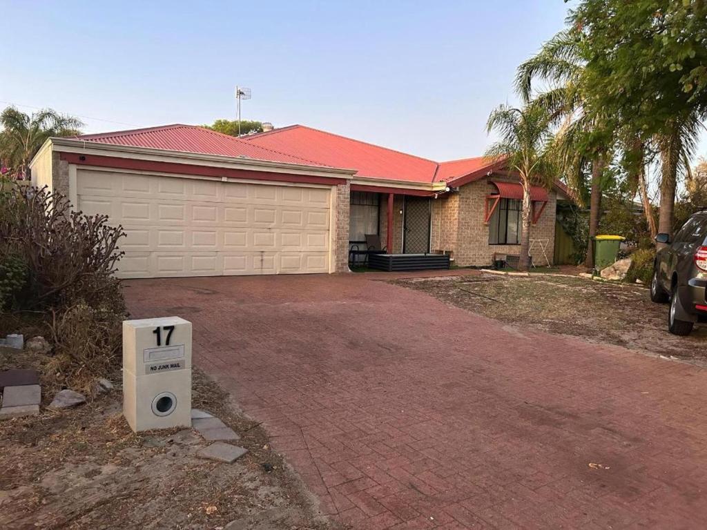 a house with a garage with a tv in the driveway at Nice house in canning vale in Perth