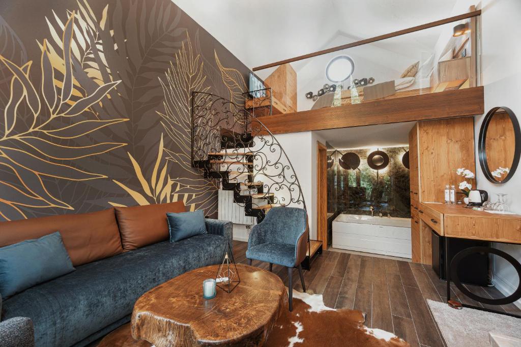 a living room with a couch and a table at Toplik Village Resort in Lukavica