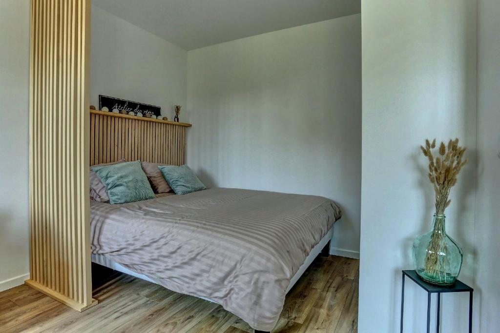 a bedroom with a bed and a large mirror at Le Normand- Bois d&#39;arcy in Bois-dʼArcy