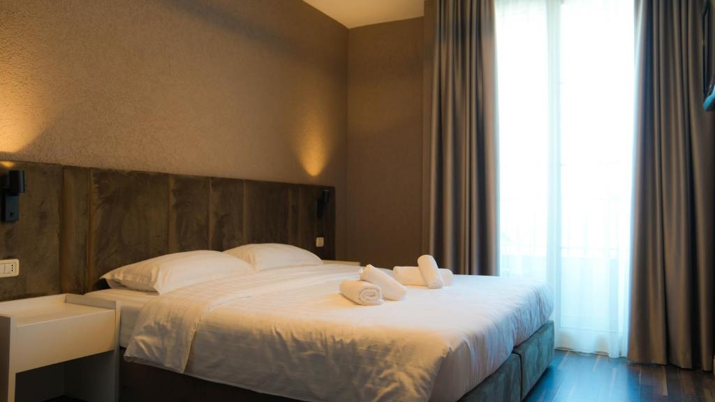Postel nebo postele na pokoji v ubytování Hotel Majestic