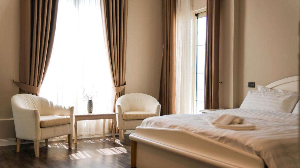 Postel nebo postele na pokoji v ubytování Hotel Majestic
