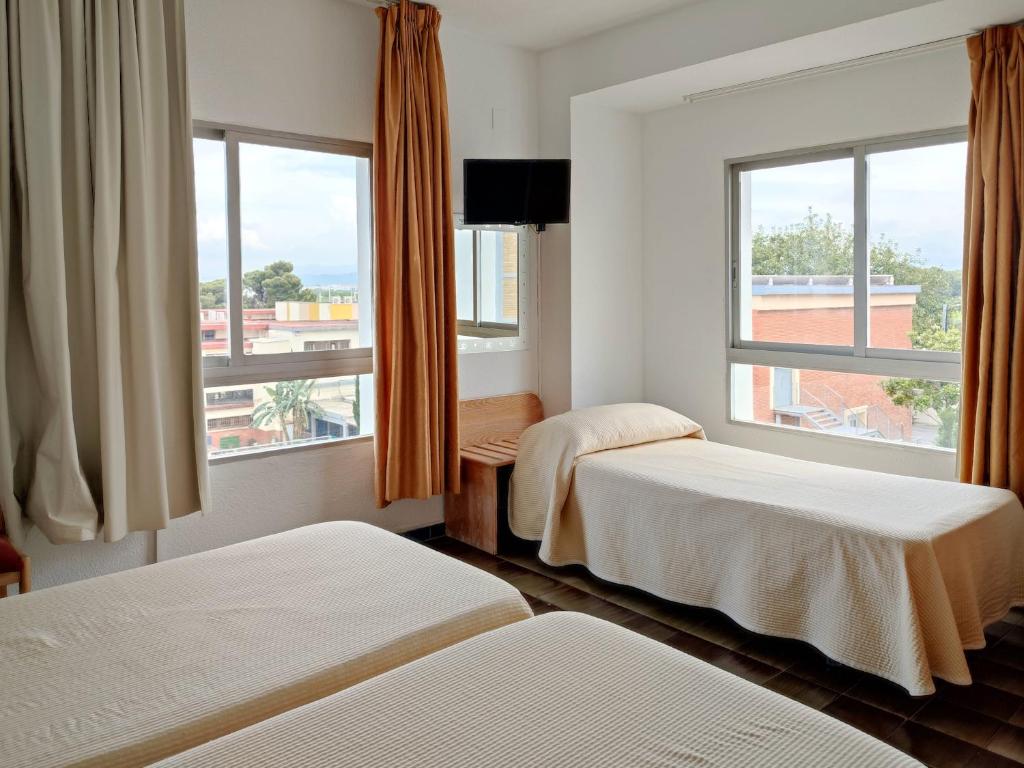 Postel nebo postele na pokoji v ubytování Hotel Porto