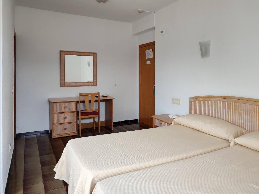 Postel nebo postele na pokoji v ubytování Hotel Porto