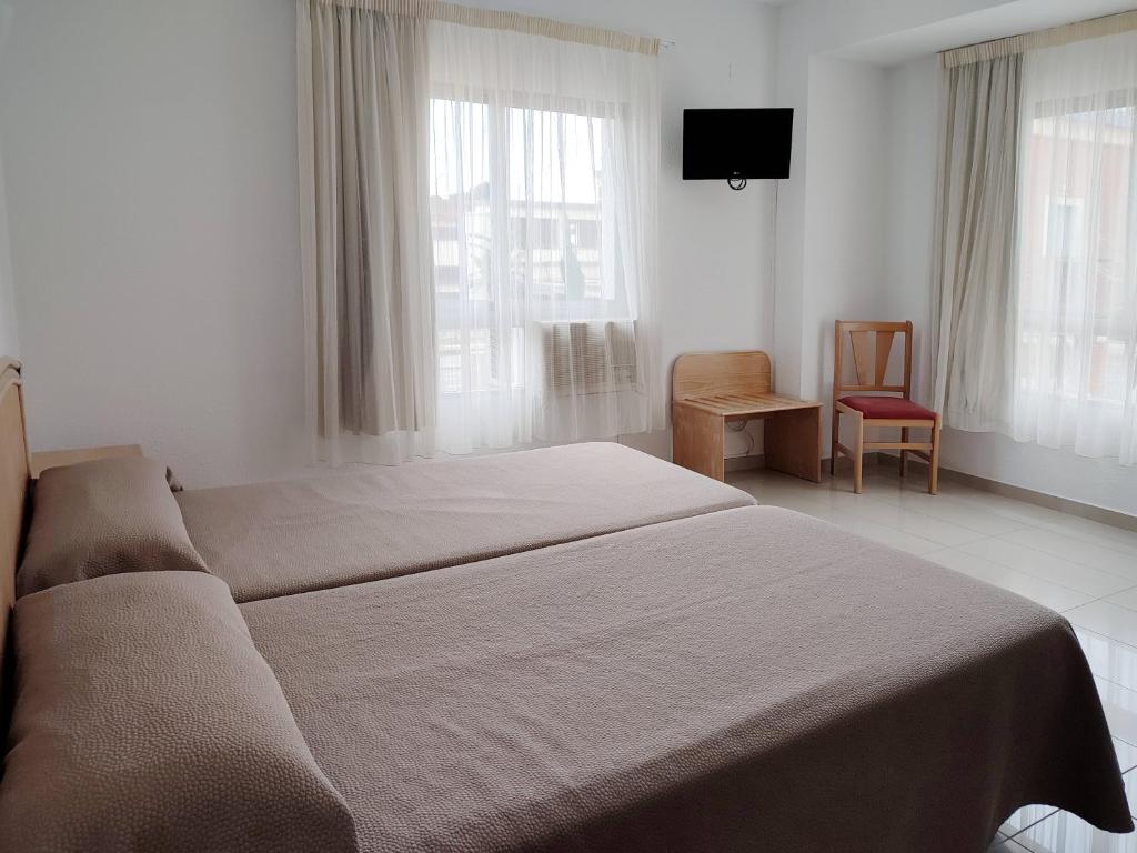 Postel nebo postele na pokoji v ubytování Hotel Porto