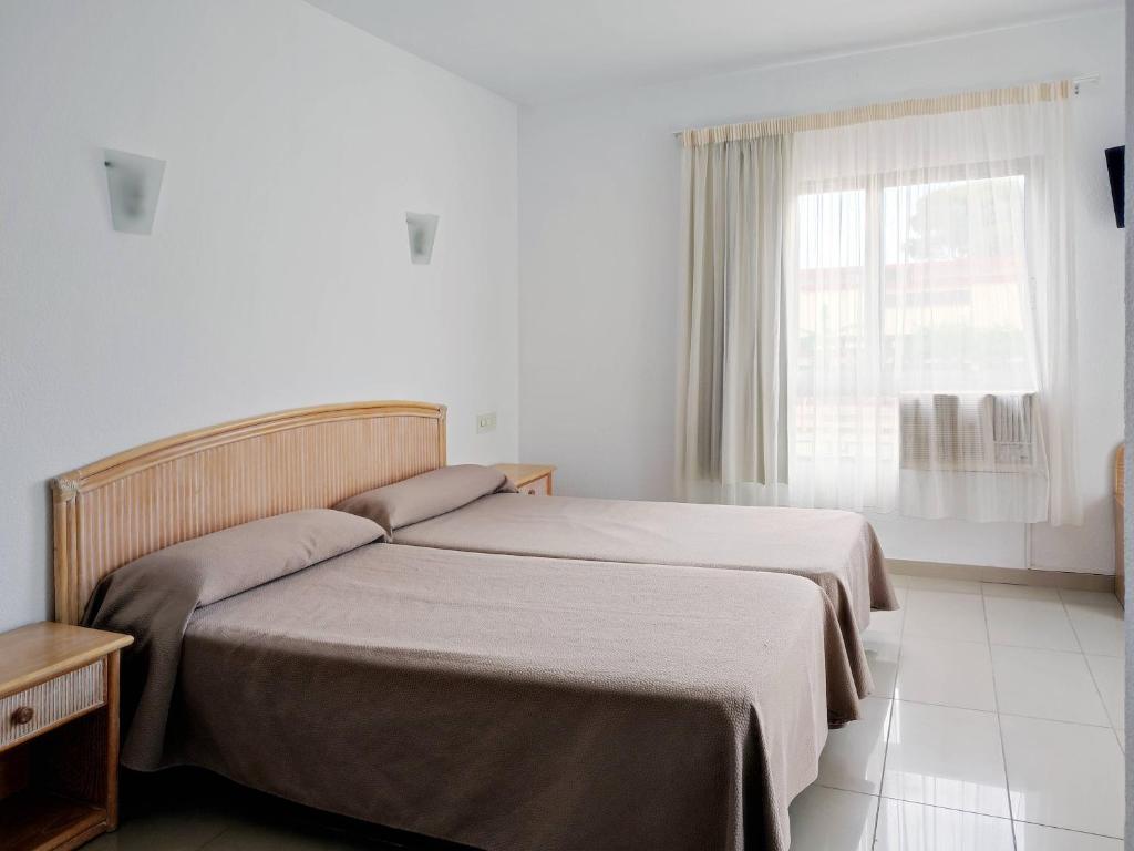 Postel nebo postele na pokoji v ubytování Hotel Porto