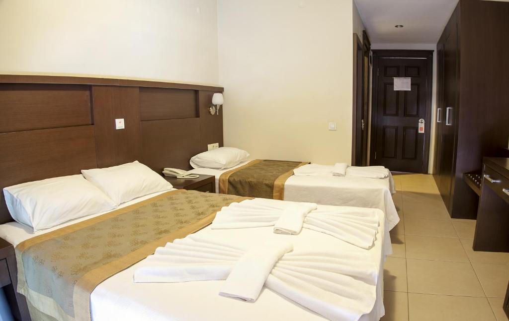 Vuode tai vuoteita majoituspaikassa Palmira Hotel
