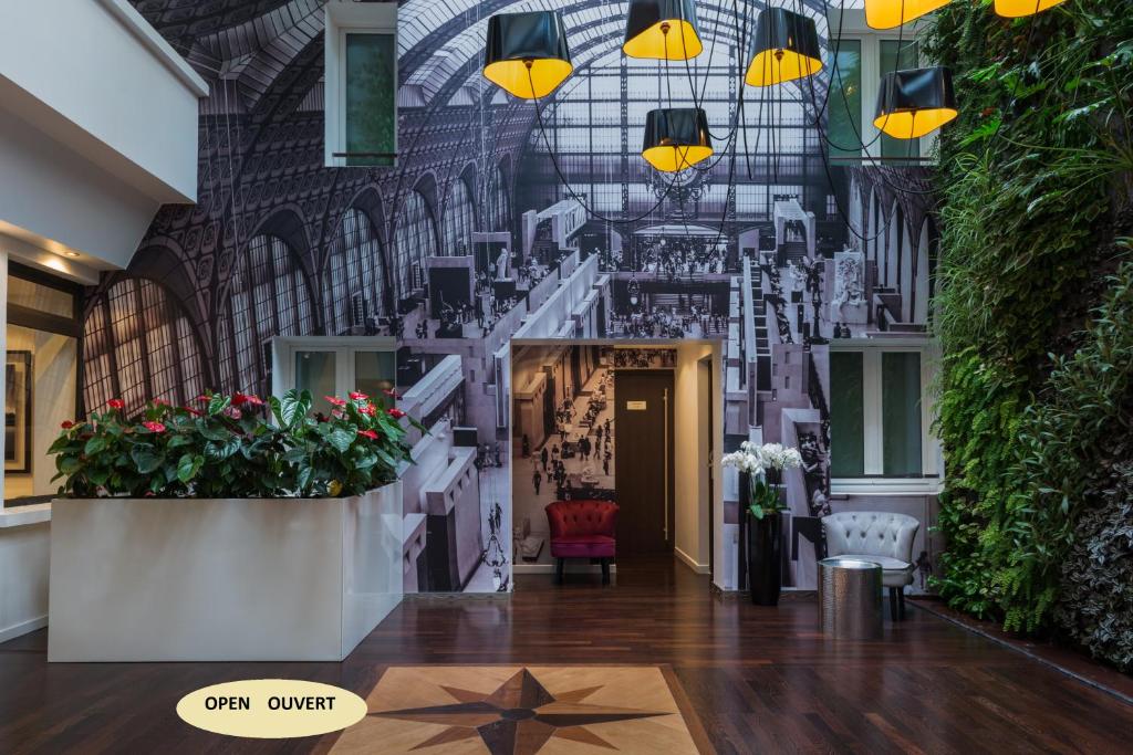 a lobby with a star on the floor and lights at Hotel Aida Marais in Paris