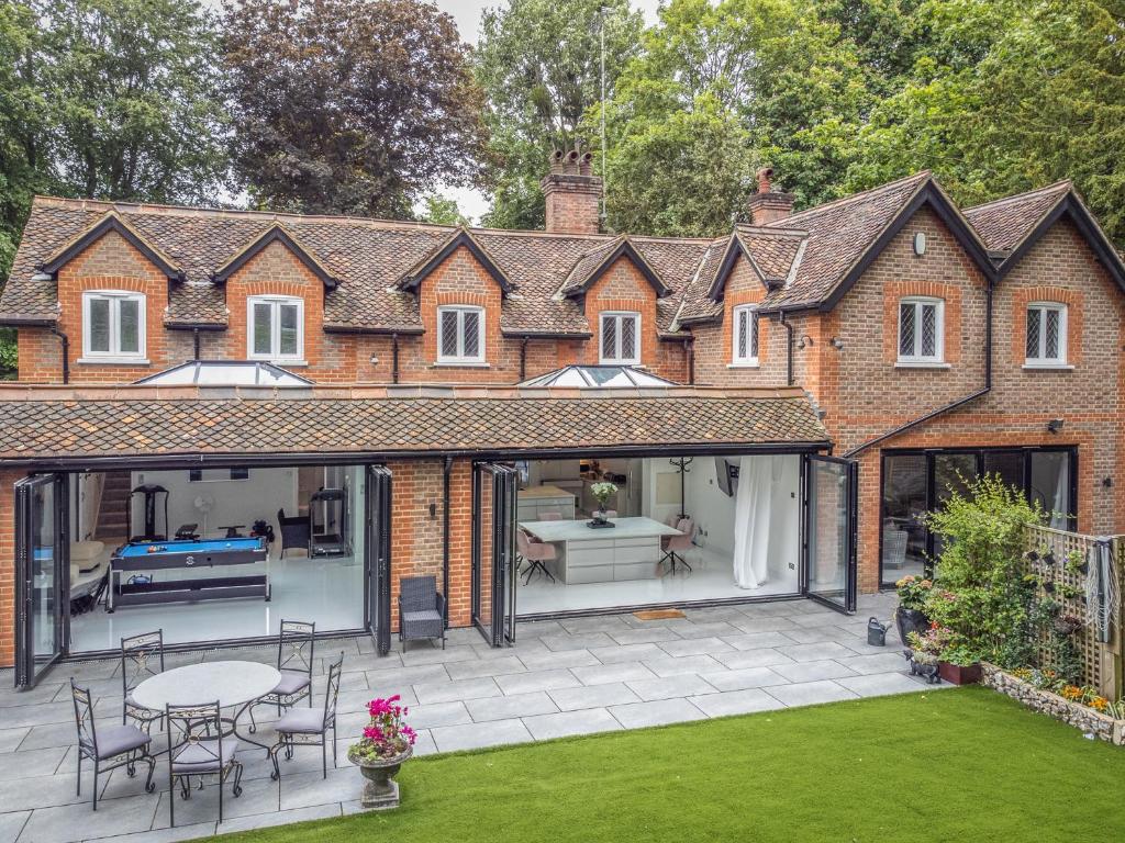 an extension to a house with a patio at Pass the Keys Prestigious 5 Bed Retreat Spacious Tranquil Haven in Radlett