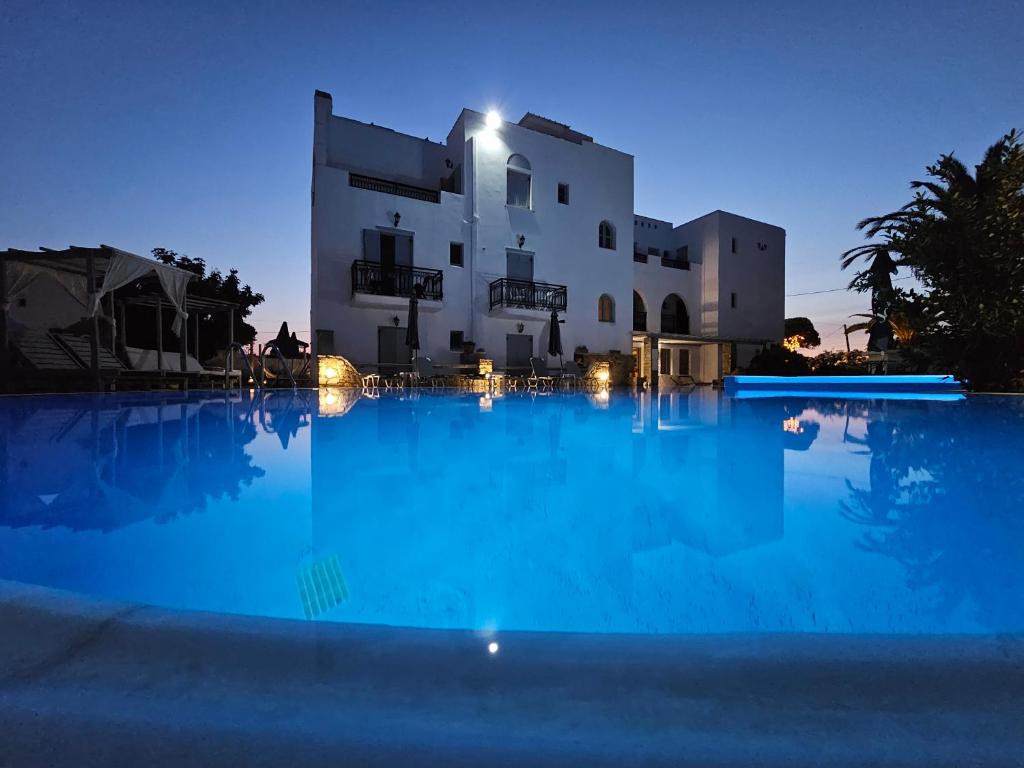 a large swimming pool in front of a building at night at Sunlight Naxos in Naxos Chora