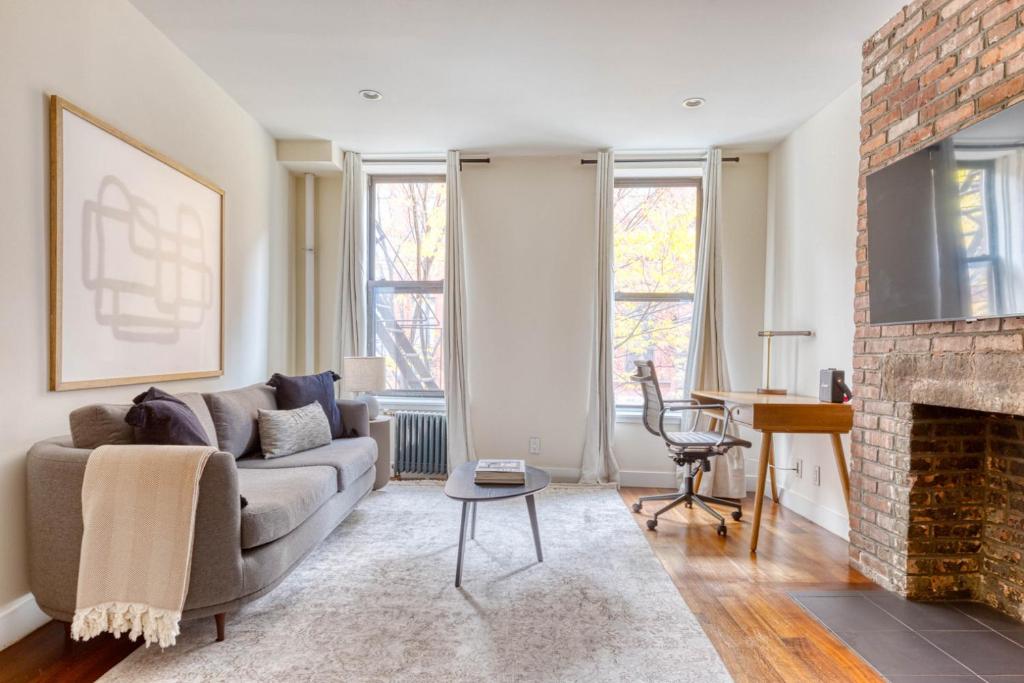 a living room with a couch and a fireplace at East Village 1br w wd nr First Park NYC-1035 in New York