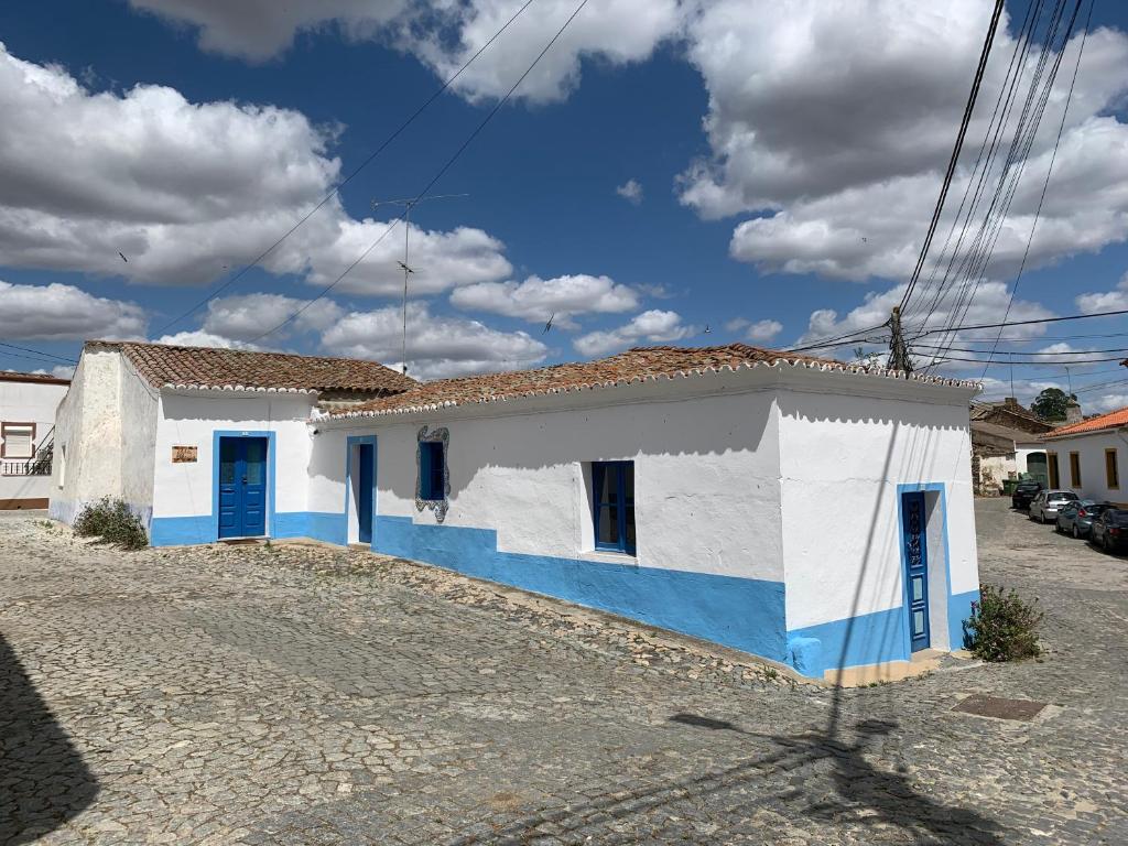 a house with blue and white paint on it at Ilha ALFRIDA in Carrapatelo